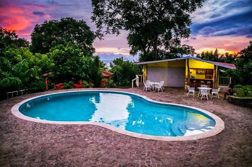 a small swimming pool in front of a house at Congos Lodge in El Perú