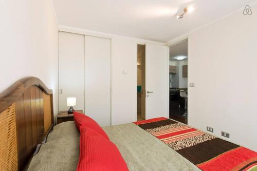 1 dormitorio con 1 cama grande con manta roja en Apartamento Vianamar, en Viña del Mar