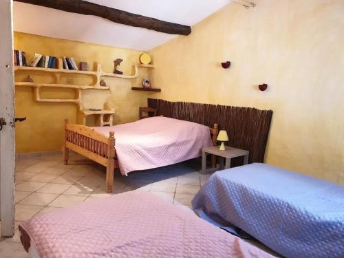 a bedroom with two beds in a room at Maison accueillante avec piscine à Meursac + Spa in Meursac