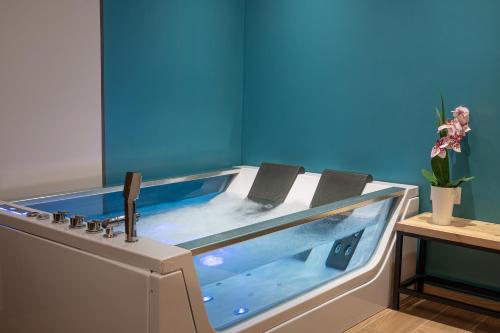 a hot tub in a room next to a table at IRA - ΗΡΑ Hotel in Kalamata