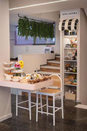 a room with a table and chairs and stairs at IRA - ΗΡΑ Hotel in Kalamata