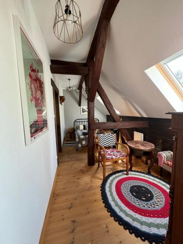 an attic hallway with wooden floors and a skylight at Siedlisko Karczówka in Wieleń