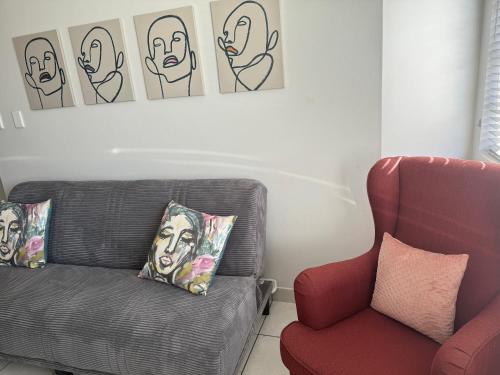 a living room with a couch and a chair at The Silhouette in Paarl
