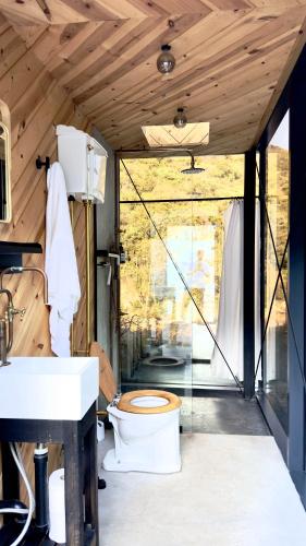 a bathroom with a toilet and a sink at Paradise Ranch Inn - Liberated Tent in Three Rivers