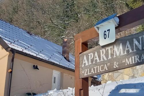 a sign in the snow next to a building at Apartments with parking spaces Kalnik, Podravina - 22913 in Križevci