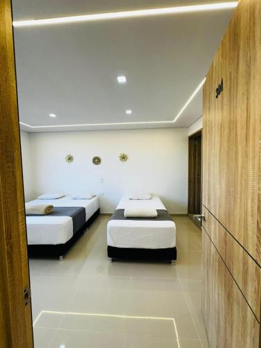 two beds in a room with two beds sidx sidx sidx at Aero Hotel Boutique in Bogotá