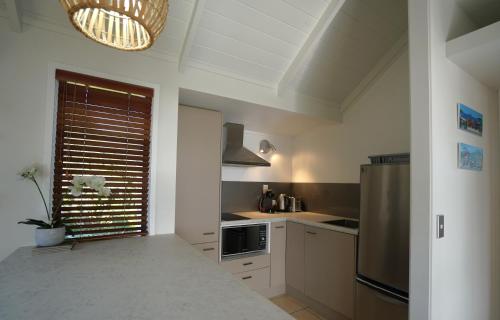 a kitchen with a stainless steel refrigerator and a window at Paradise Palm Beach, Hot Tub in Palm Beach