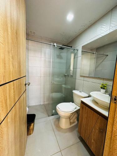 a bathroom with a toilet and a sink and a shower at Aero Hotel Boutique in Bogotá