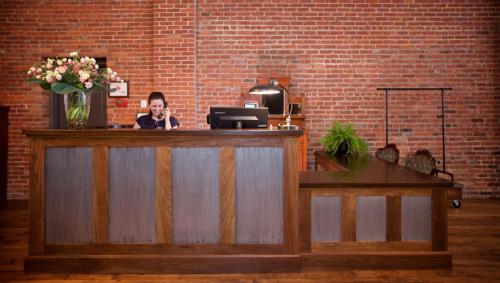 a man talking on a cell phone at a counter at Hotel on North in Pittsfield