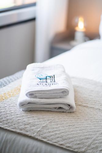 a pile of towels sitting on top of a bed at Atlantic View Appart'Hotel in Casablanca
