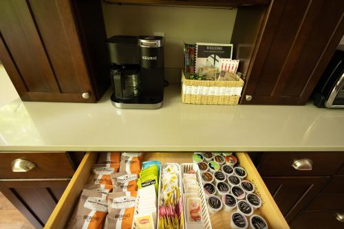a cupboard filled with food and a coffee maker at 5br, 9 Beds Sleeps 14 Game Room, Pool Access in Gaylord
