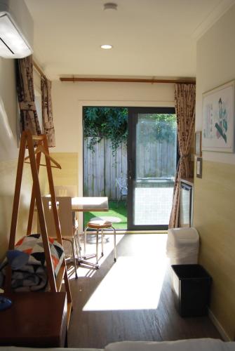 a living room with a table and a window at Energy Motor Lodge Papamoa in Tauranga