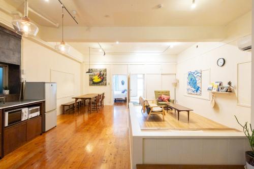 a living room with a kitchen and a dining room at Pineapple Hotel in Naha