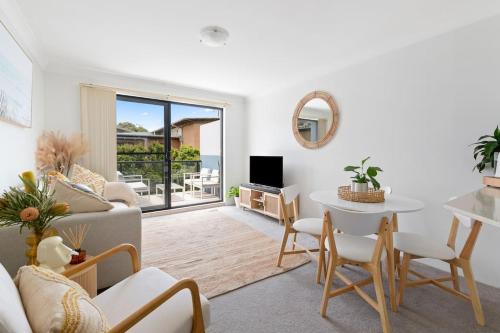 a living room with a couch and a table at Chic Brookvale Unit-Big Balcony! in Sydney
