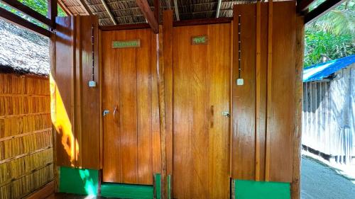 a wooden paneled wall in a room at Nyande Raja Ampat in Pulau Mansuar