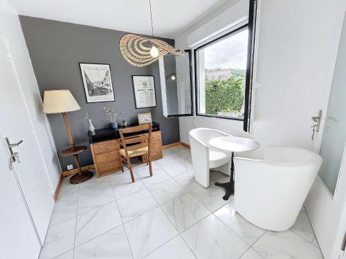 a bathroom with a toilet and a sink and a window at Maison calme, proche plage et commerces à Jullouville, jardin clos, 3 chambres, idéale vacances - FR-1-361-381 in Jullouville-les-Pins