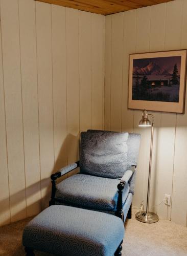 a chair and a lamp in a room with a chair at Alaska Cozy Cabins in Wasilla