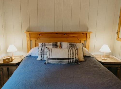 a bedroom with a bed with two lamps on tables at Alaska Cozy Cabins in Wasilla