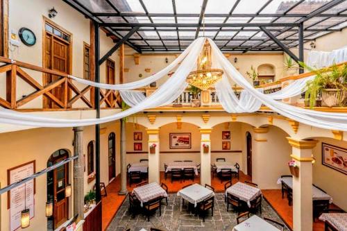 a room with tables and chairs in a building at Hostal La Suite in Sangolquí