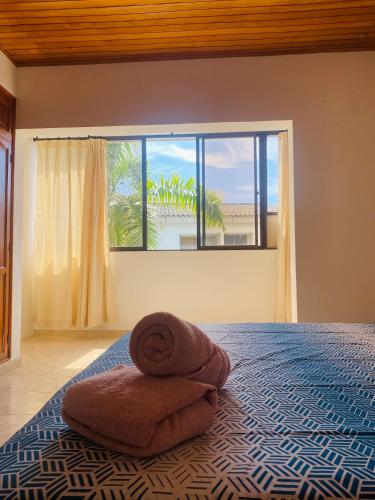 a bedroom with a bed with two towels on it at Paraiso Pie de la Popa in Cartagena de Indias