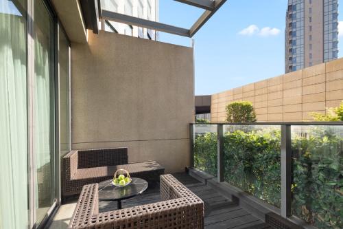 a balcony with a table and chairs on a building at Fraser Place Wujiaochang Shanghai - Adjoin business center, free minibar in Shanghai