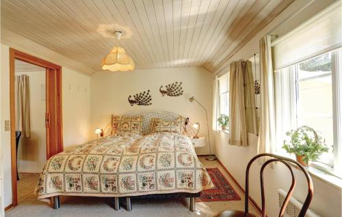 a bedroom with a bed in a room with windows at Bakketop in Balke