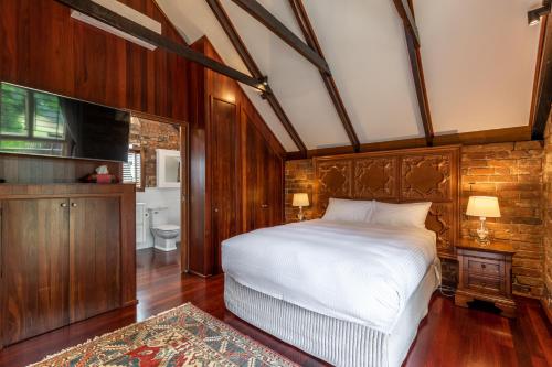 a bedroom with a large bed and a bathroom at Bon Accord Boutique Accommodation in Sale