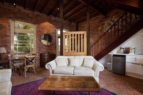 a living room with a couch and a table at Bon Accord Boutique Accommodation in Sale