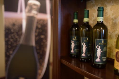 a group of bottles of wine sitting on a shelf at Hotel Imperial Premium in Timişoara