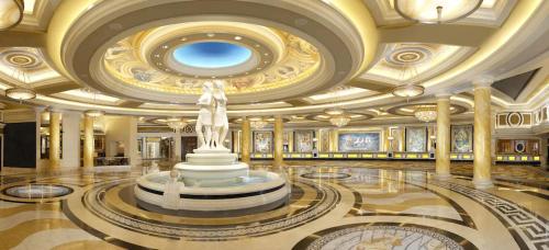 a lobby with a statue in the middle of a building at Caesars Palace Las Vegas by Suiteness in Las Vegas