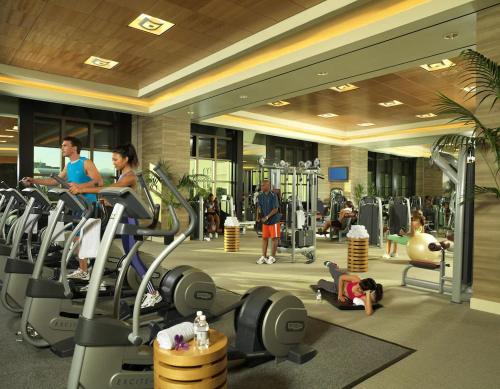 a gym with people exercising on treadmills and machines at Caesars Palace Las Vegas by Suiteness in Las Vegas