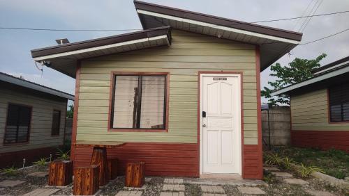 a small house with a door and a window at Olango Transient Home,with WIFI &Netfix in Santa Rosa