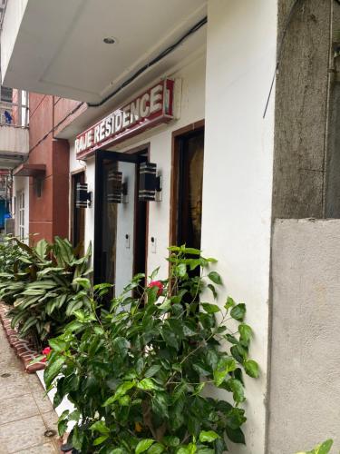 a sign on the side of a building with plants at Raje Residence in El Nido
