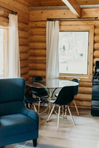a dining room with a table and chairs and a window at Fun Alaska Log Cabin on Wooded Property! in Wasilla