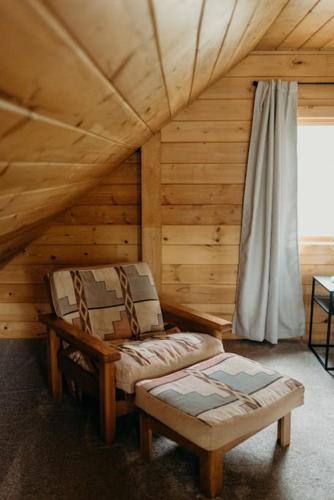 a room with a bench and a window in a cabin at Fun Alaska Log Cabin on Wooded Property! in Wasilla