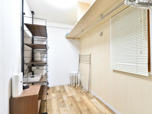 a living room with a staircase and a window at シャトーひらぎし in Sapporo