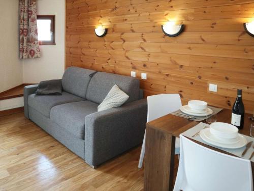 un salon avec un canapé et une table dans l'établissement Studio cosy pour 2 en centre station, vue sur les pistes - FR-1-322-629, aux Orres