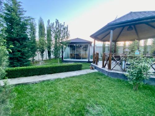 a garden with a gazebo and a building at Villa Lux in Quba in Quba