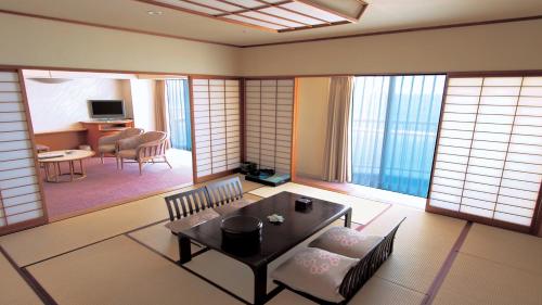 a living room with a table and chairs in a room at Irago Resort & Convention Hotel in Tahara