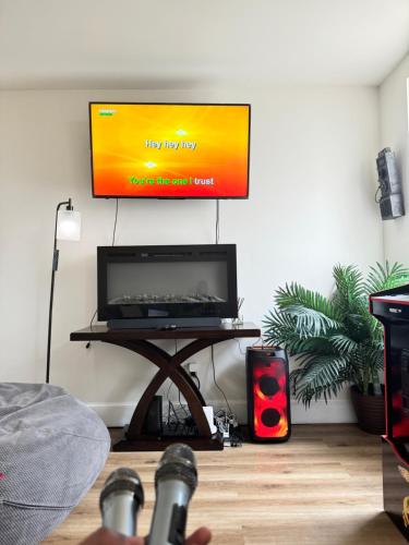 a flat screen tv on a wall in a living room at Downtown Home - Close to Topgolf, Ravens Stadium, Orioles Park, UM Baltimore in Baltimore