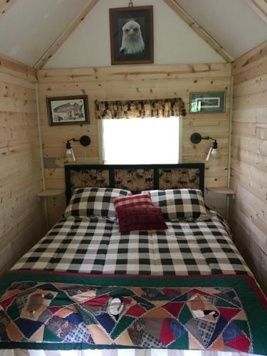 a bedroom with a bed in a tiny house at Homestead cabin in Homer