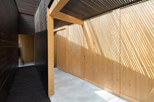 a hallway of a building with wooden walls at Awrawikara by REJA Reserve in Bogor