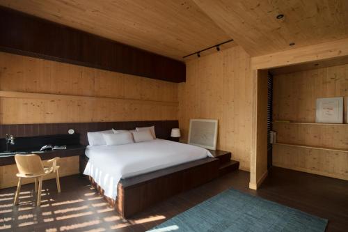 a bedroom with a bed and a desk and a chair at Awrawikara by REJA Reserve in Bogor