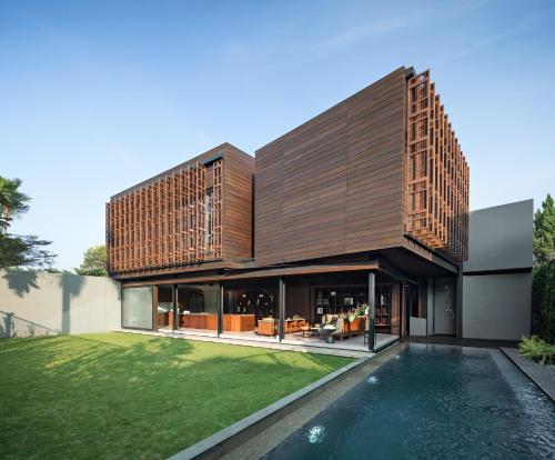 an external view of a house with a swimming pool at Awrawikara by REJA Reserve in Bogor
