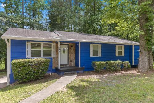a blue house with a tree in front of it at 5BD 2BTH Home Near Hartsfield Jackson Airport in College Park