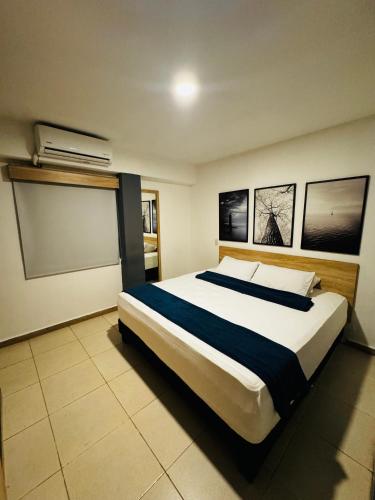 a bedroom with a large bed in a room at HOTEL MEDELLIN CENTRAL in Medellín