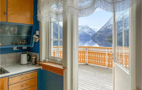 a kitchen with a large window and a view of a lake at 3 Bedroom Nice Home In Valldal in Valldal