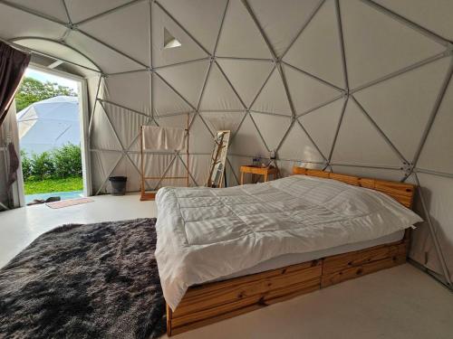 a bedroom with a large bed in a tent at NiNo San Glamping - Pak Chong in Pak Chong