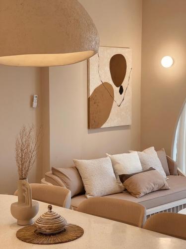 a living room with a couch and a table at Stay Raum in Jakarta