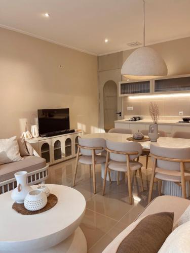 a kitchen and living room with a table and chairs at Stay Raum in Jakarta